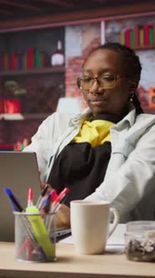 Woman Relaxing at Desk with Laptop and Coffee