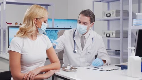 Woman Getting a Vaccination from a Doctor