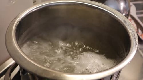 Water Boiling Vigorously in Silver Metal Pot