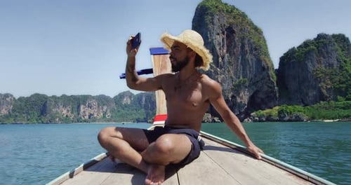 Man Taking Photos on a Boat Tropical Islands