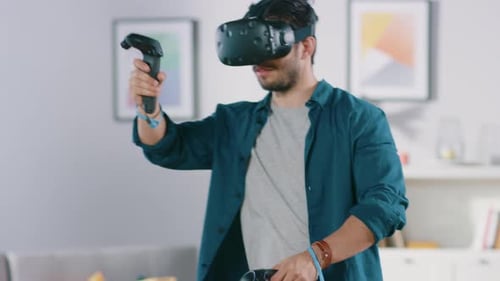 Man Using Virtual Reality Headset and Controllers Indoors