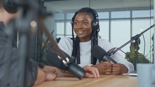 Two Young Men in a Recording Studio Create Audio Content Record a Podcast