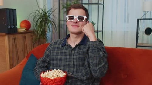 Young Man Watching 3D Movie With Popcorn