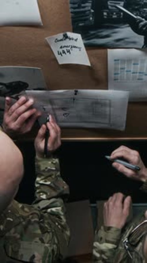 Commanders Discussing Military Strategy on Board at Office