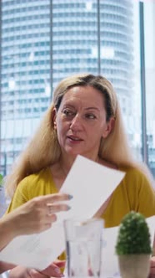 Vertical Video Consultant in Office Assisting People in Setting Up Living Expenses Plan
