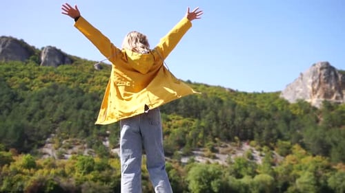 Woman Enjoying Nature with Arms Outstretched