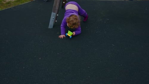 Child Plays With Toy Truck on Playground