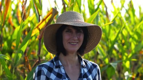 Happy Smiling Female Farmer Looks Into Camera Standing Near Corn Field Portrait of Adult Beautiful