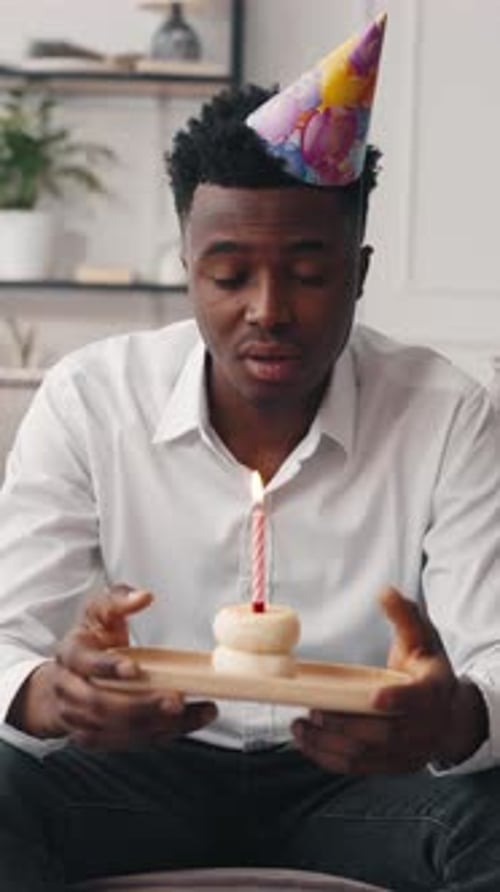 Lonely Sad Black Man Celebrating Birthday Alone at Home Portrait with Cake Vertical Video African