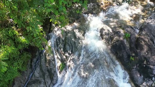 Tropical Waterfall Cascades from Above in Green Nature