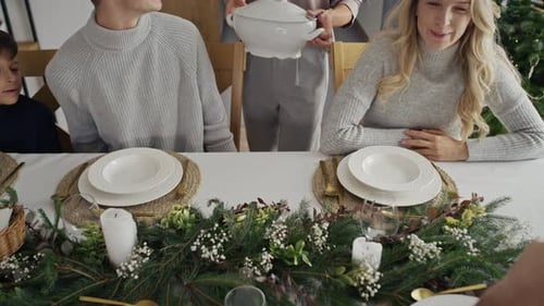Family Gathering Together for Festive Christmas Dinner