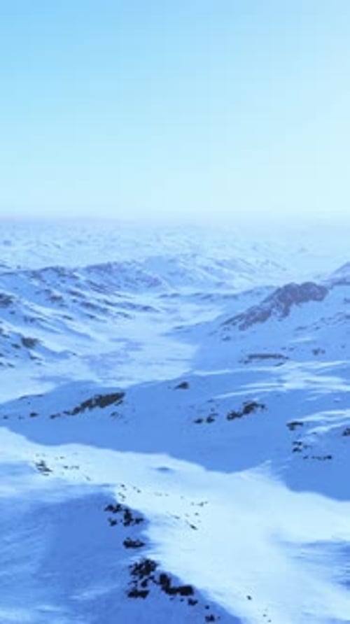A Snowcovered Mountain Range Under a Clear Blue Sky