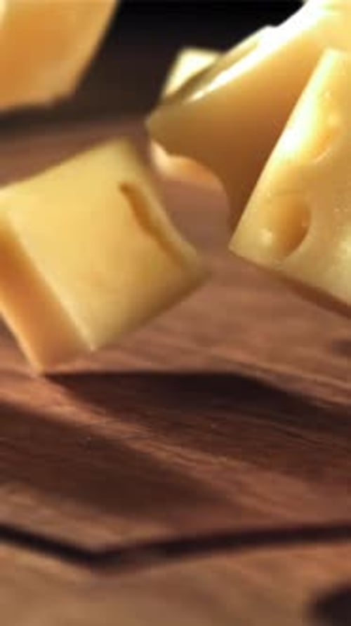 Super Slow Motion Pieces of Cheese Fall Onto a Cutting Board Filmed on a Highspeed Camera at 1000