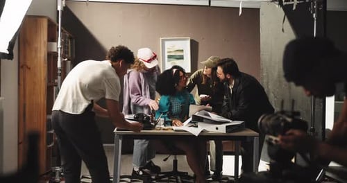 Actress, director and meeting with staff on film set with script review