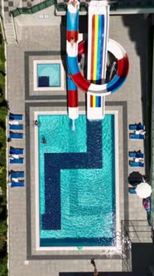 Vertical Video Family Water Park with Large Pool and Fun Slides for Children and Families Enjoying