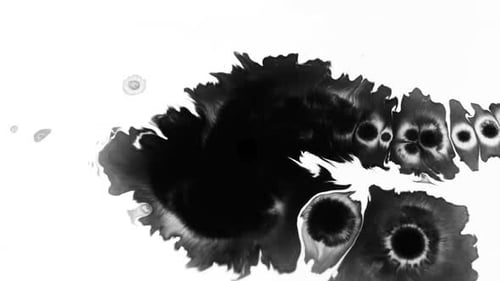 Abstract Black Ink Drop Spreading on White Surface