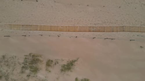 Empty Trail Passing Desert with Low Green Shrub Aerial View Path Running Sand