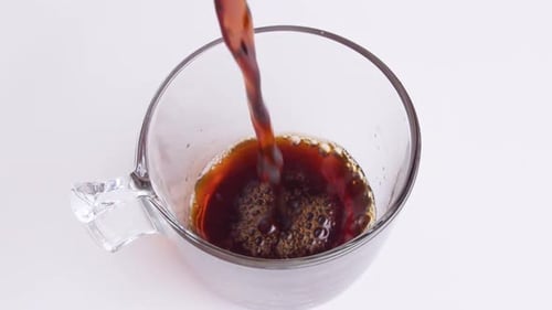 Coffee Pouring into a Clear Glass Mug