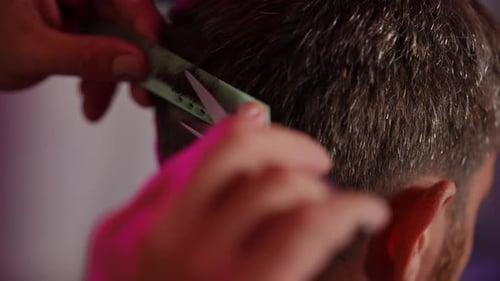 Man Getting Haircut with Scissors and Comb