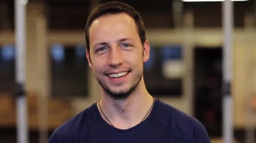 Smiling man in blue shirt close up portrait