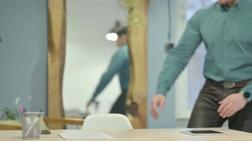Mature Adult Man Coming Back to Office Desk