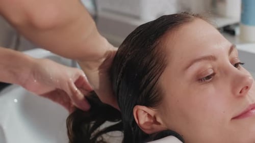 Women Enjoying Professional Shampoo and Tranquil Spa Scalp Care Relaxed Woman Receiving Expert Hair