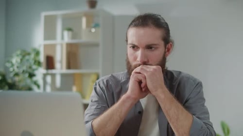 Man Concentrating Working on Laptop at Home