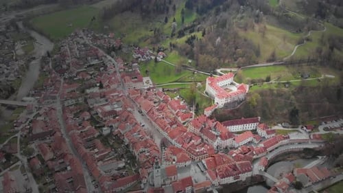 Round drone shot of a castle and museum Skofja Loka, Slovenia. A historic medieval castle in Sloveni