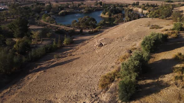 Aerial push-in over Neot Smadar oasis - Israeli desert landscape with ...