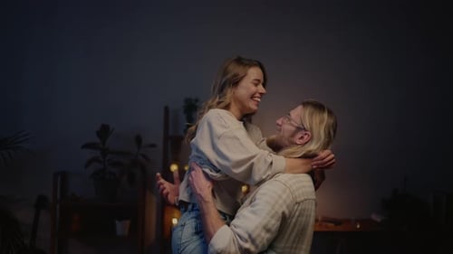 Happy Couple Laughing and Embracing at Home