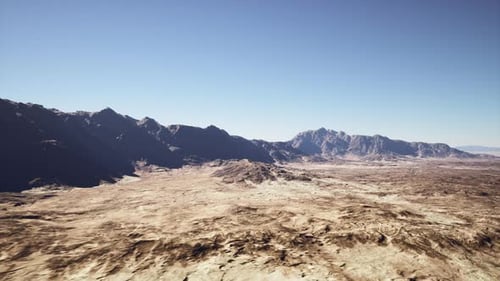 Wideangle Photograph Capturing Blazing Desert with Distant Mountain Range