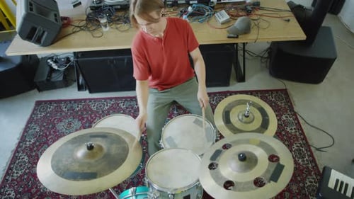Top Down of Man Playing Drumset