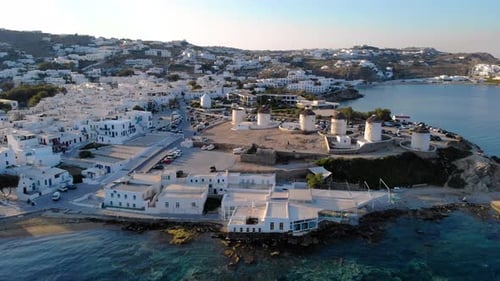Exploring the Charming Windmills and Coastline of Mykonos Greece During Sunset