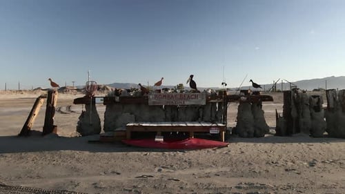 Flying Towards The Bombay Beach Marina With Steel Birds Sculpture At Bombay Beach In Salton Sea, Cal