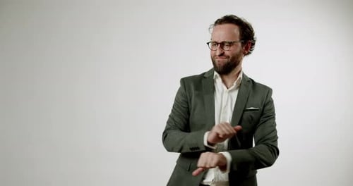 Awkward Businessman Dances Funnily in Suit and Glasses on White Background