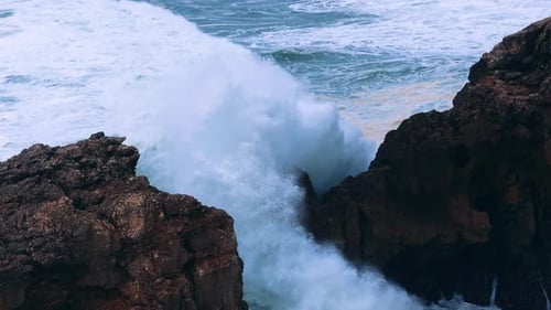 Powerful Slow Motion Ocean Waves Crashing Through Rocky Cliffs