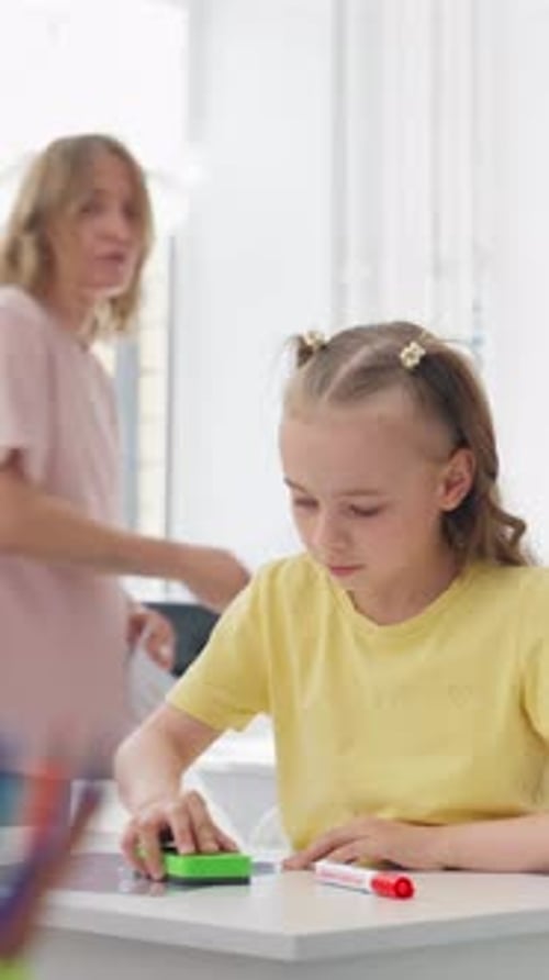 Young Girl Drawing at a Sunlit Table in a Minimal White Room