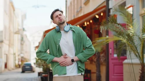 Man Tourist Feeling Sudden Strong Abdominal Stomach Ache Diarrhea Gastritis Problem on City Street