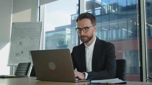Young Businessman Working at Laptop Computer Look at Screen Thinking Analyzing Online Trading Market