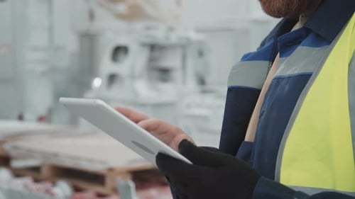 Man using Tablet in a Construction Workplace