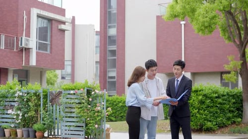 A wealthy couple customer shakes hands and thanks real estate insurance agent for successful sale of