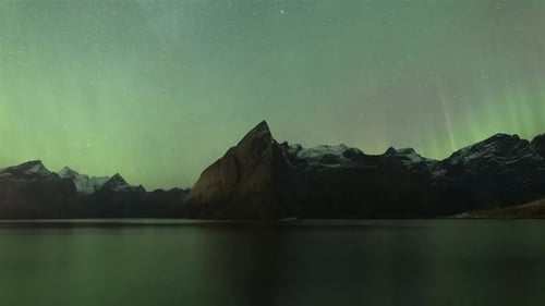 Time Lapse of spectacular aurora borealis over Reinefjord, Lofoten