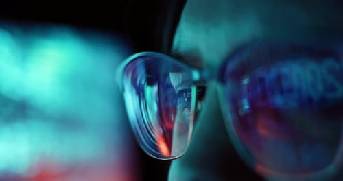 Person with Futuristic Glasses Reflecting Computer Screen