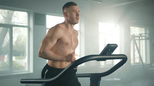 Medium Shot of Young Athlete Running Slow and Fast on Treadmill in Gym