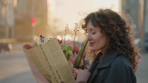 Intimate Image of Woman Smiling with Flowers in Warm City Illumination Close View of Female Florist