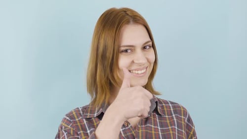 Woman Giving a Thumbs Up and Smiling