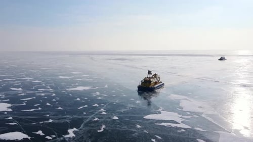 Ein Eisbrecherschiff, das im Winter durch gefrorenes Meereis navigiert, aus der Luftperspektive