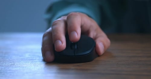 Close Up Male Hand Scrolling Wheel and Clicking Buttons with Computer Mouse