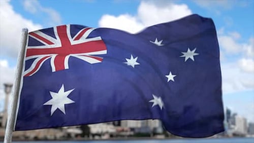 Australian Flag Waving Proudly Against City Backdrop