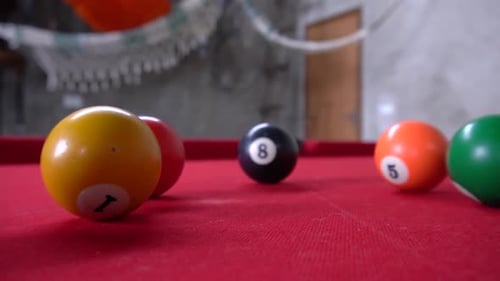 Snooker is a game that consists on making the balls get inside the holes by using a wooden stick to